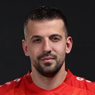 Man wearing a red sports jersey on a black background.
