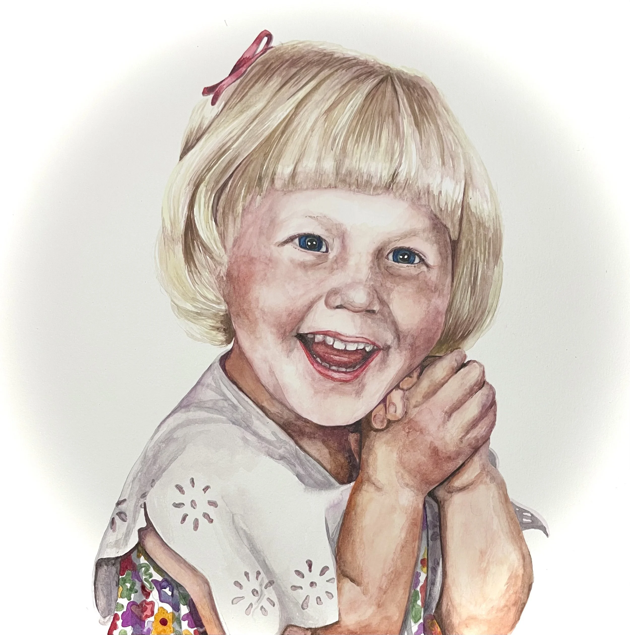A realistic watercolor-style painting of a young girl with blonde hair, blue eyes, and a wide smile showing her teeth. She wears a white shirt with floral accents on the sleeves, and a pink hair clip in her hair. Her hand is near her face.