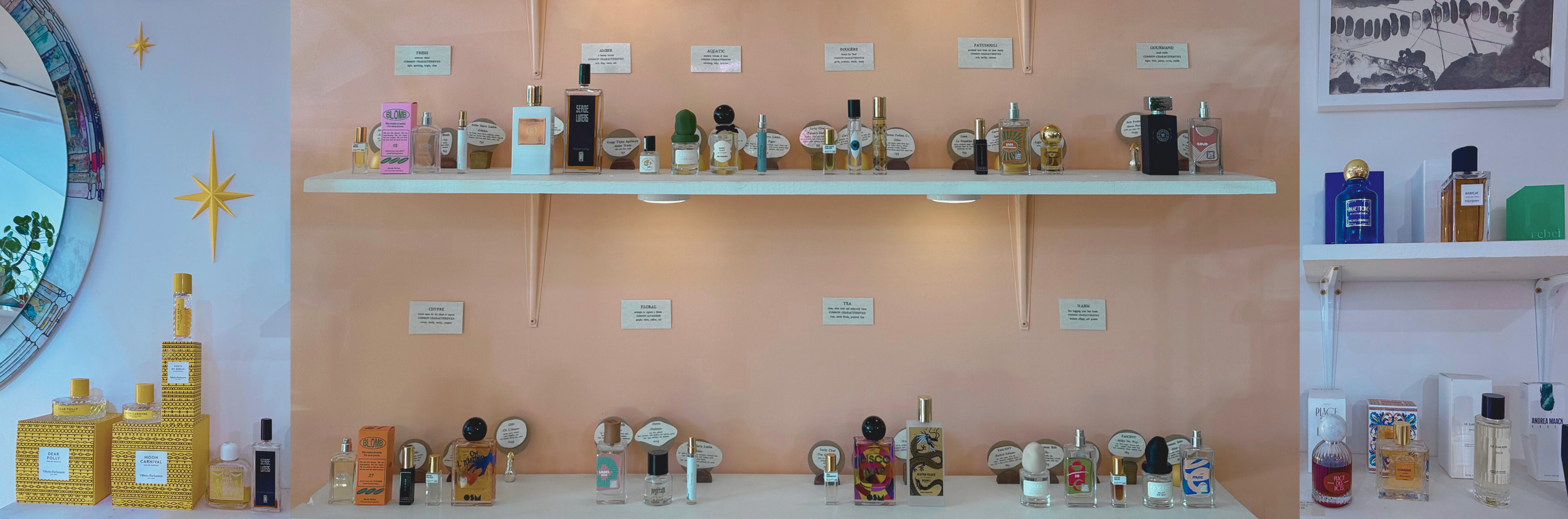 Display of various perfume bottles on shelves and tables, with some labels and décor.
