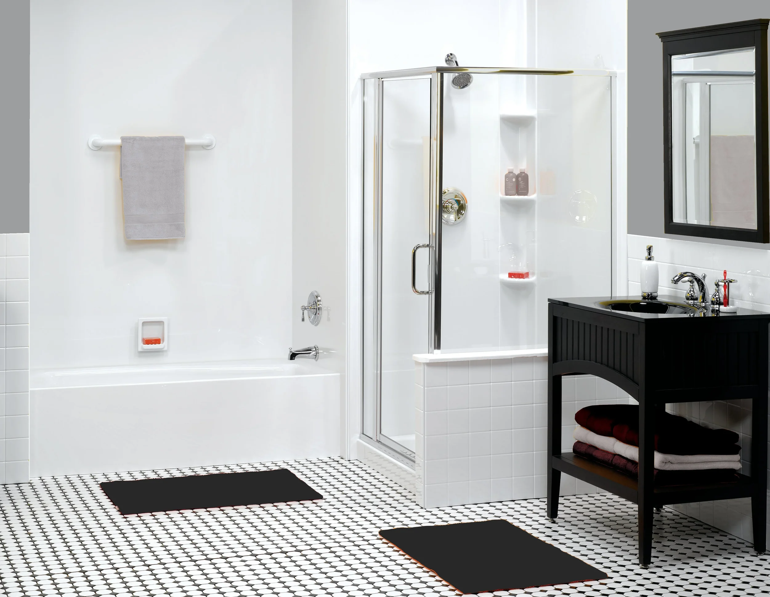 Modern bathroom with a bathtub, glass shower, black vanity, and patterned tile—all at a fair bathroom remodel price.
