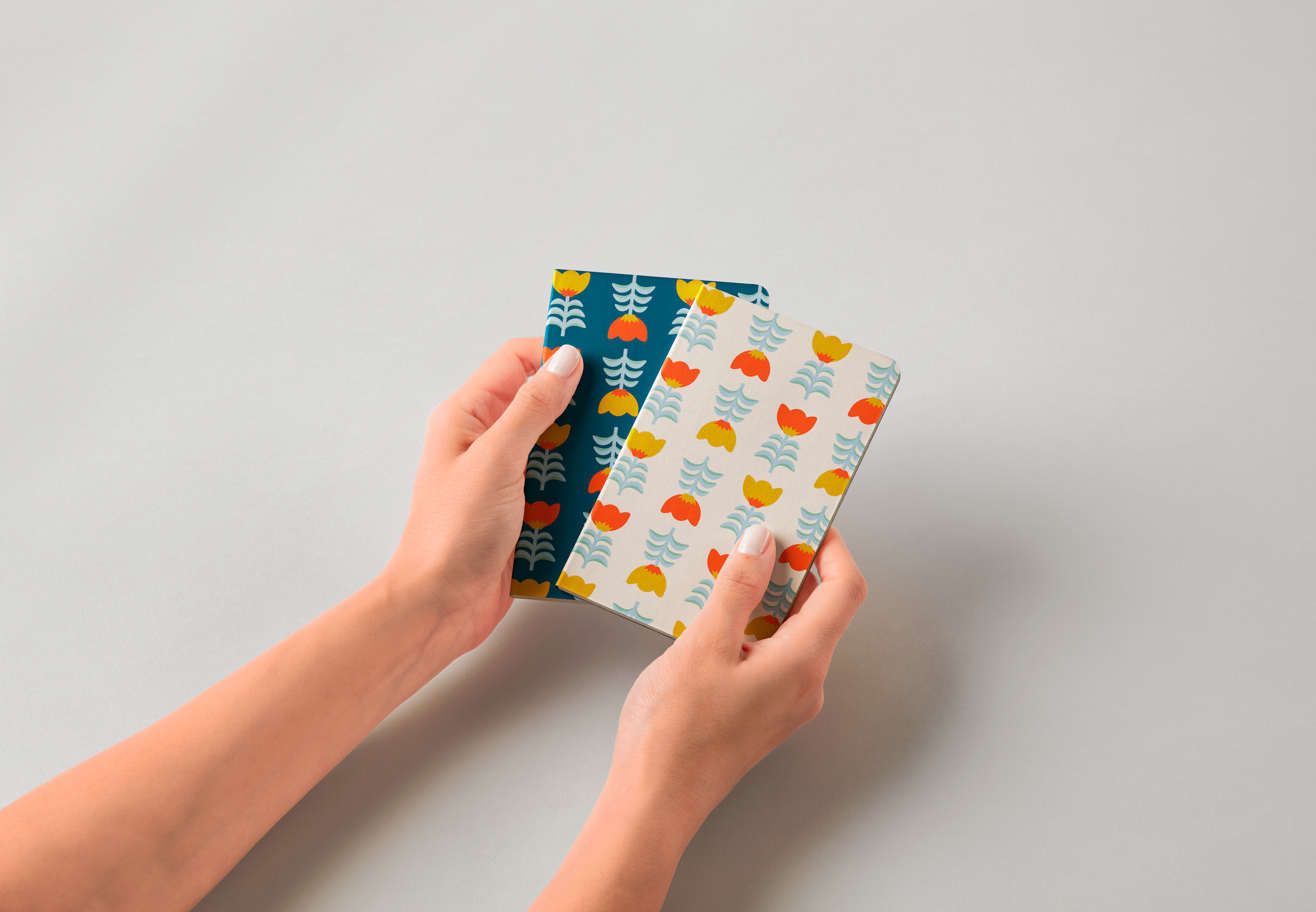 Hands-Holding-Pocket-Classic-Notebooks-Free-psd-Mockup.png