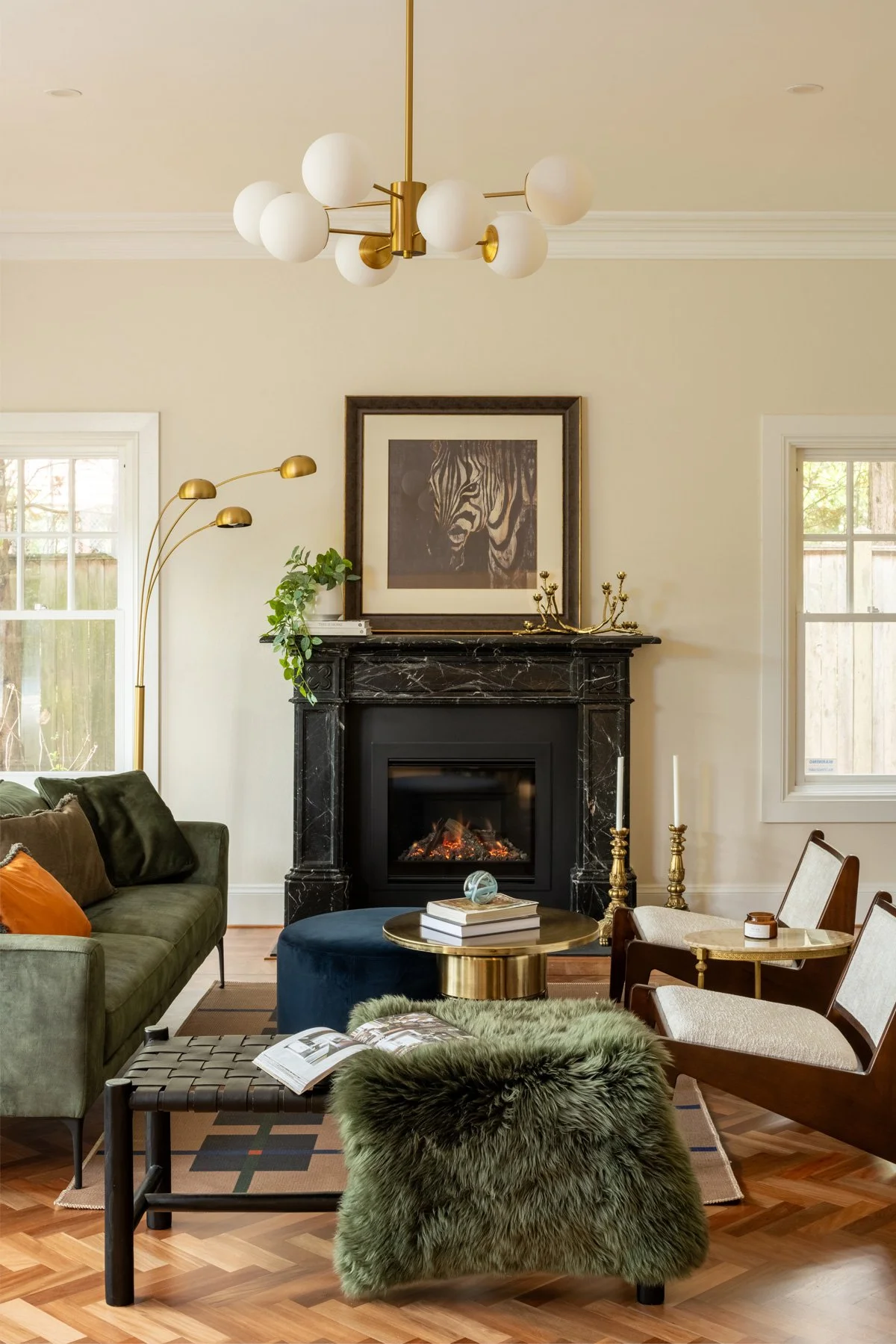 Bespoke interior styling in a heritage Sydney home — formal living room with marble fireplace, green velvet sofa and brass chandelier