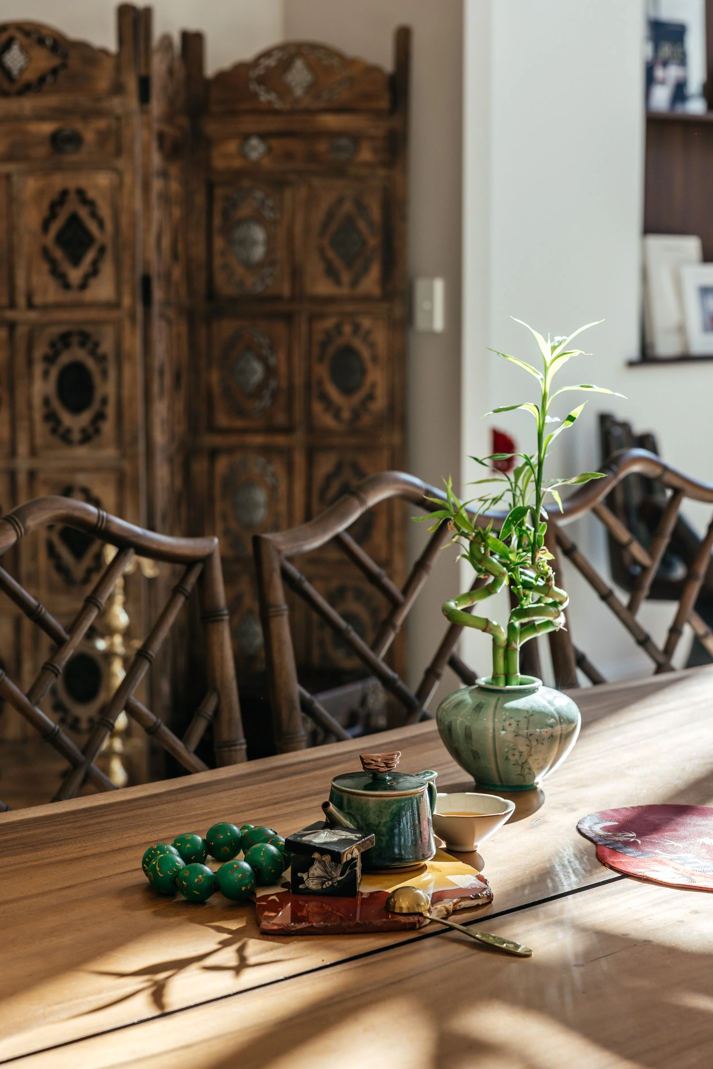 Traditional green tea set with a bamboo plant in a ceramic vase, styled by SYP Homes for interior decor inspiration.