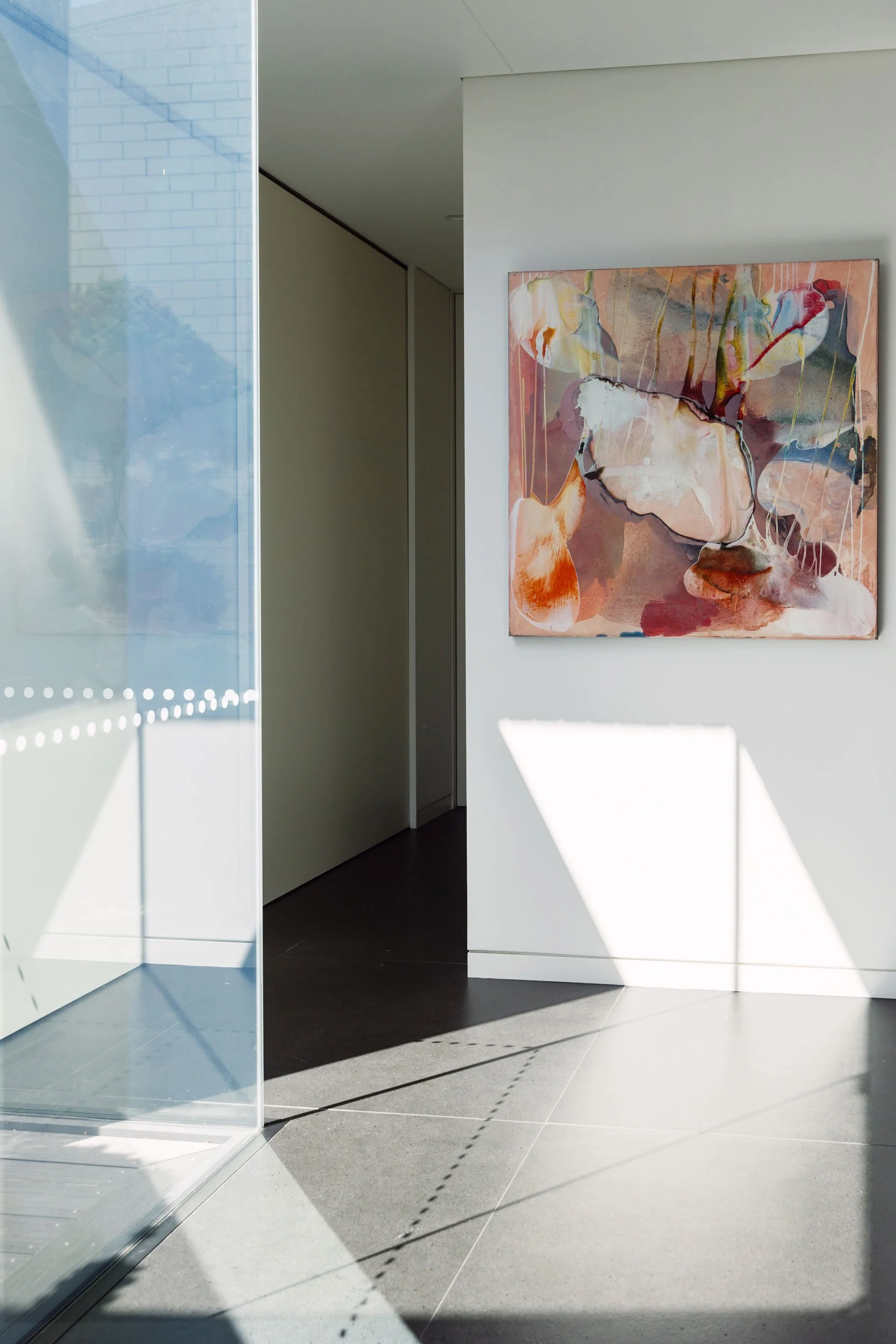 Art placement within a modern hallway space