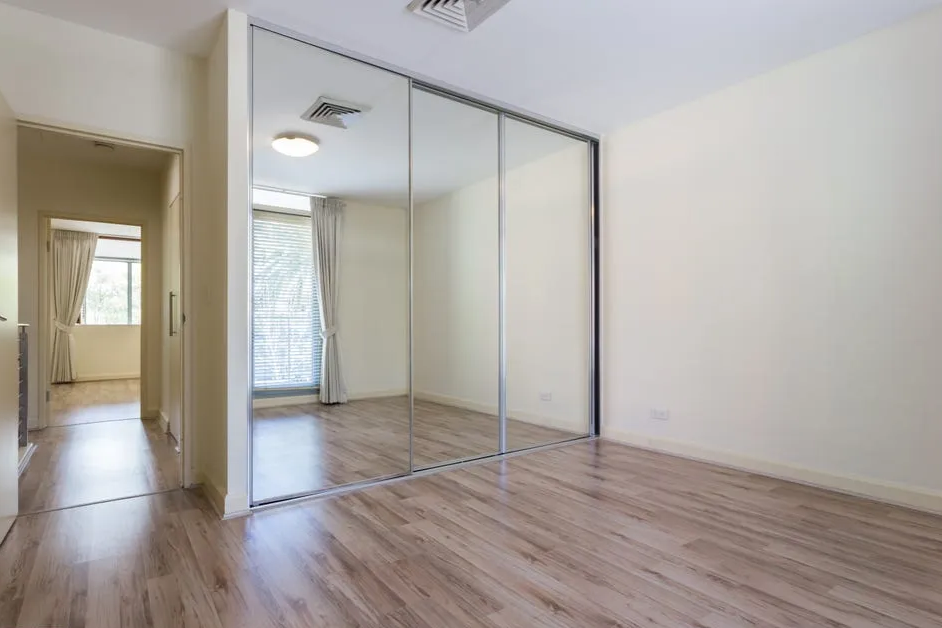 Empty bedroom before conversion — bare room with mirrored wardrobe — interior styling Sydney — SYP Homes