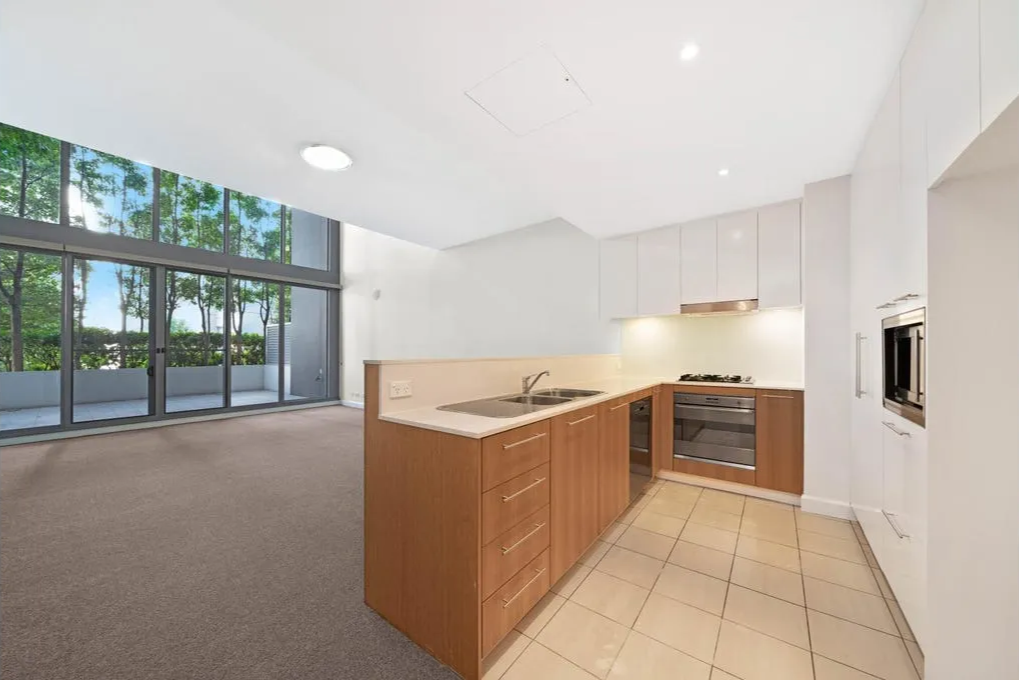 Empty apartment before interior styling — open plan kitchen and living space — SYP Homes Sydney