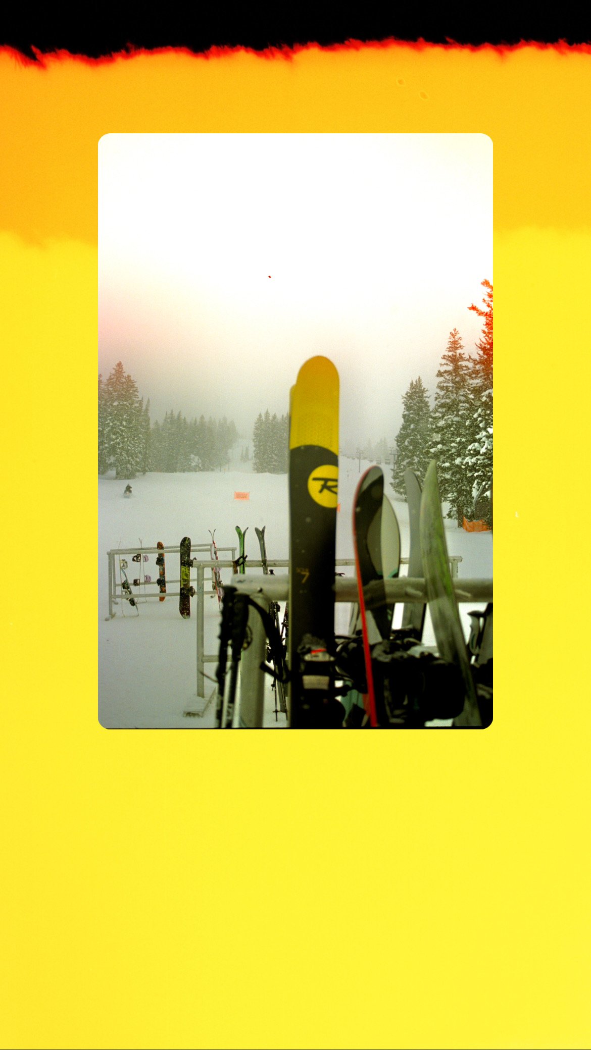 Skis and snowboards on a rack in a snowy landscape with trees and distant skier, framed by a yellow border.