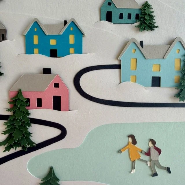 Macro of paper houses tucked into a cut snow layer in the Winter Wonderland illustration