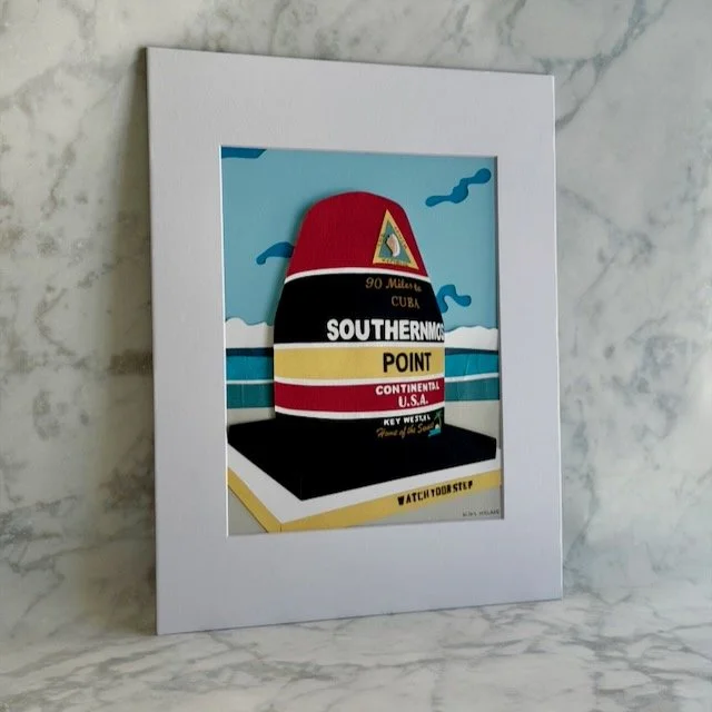 Southernmost Point paper illustration shown at an angle, the buoy and sky layers lifting off the background