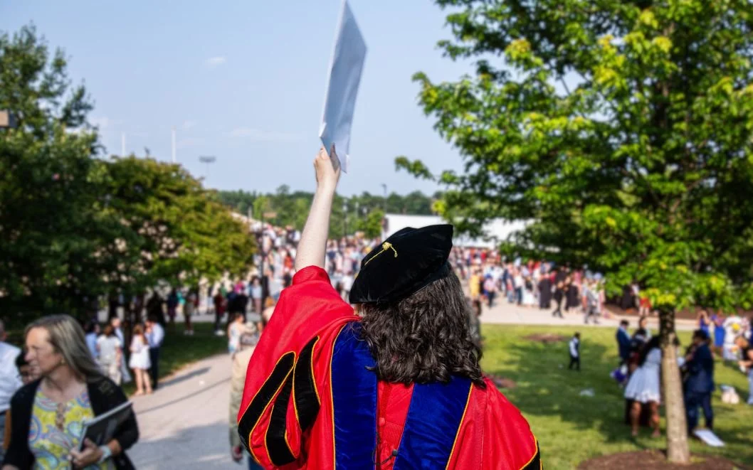 Graduate celebrating a milestone moment, symbolizing clarity and forward momentum in a career journey