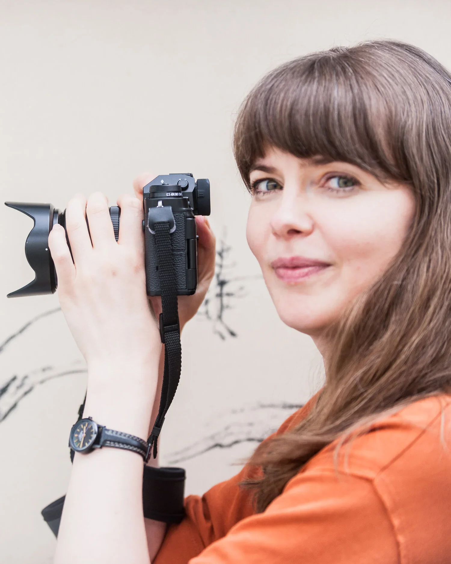Anastasiya Bulkavets, founder of The Arigato Co. and Shopify web designer based in Kyoto, holding a camera