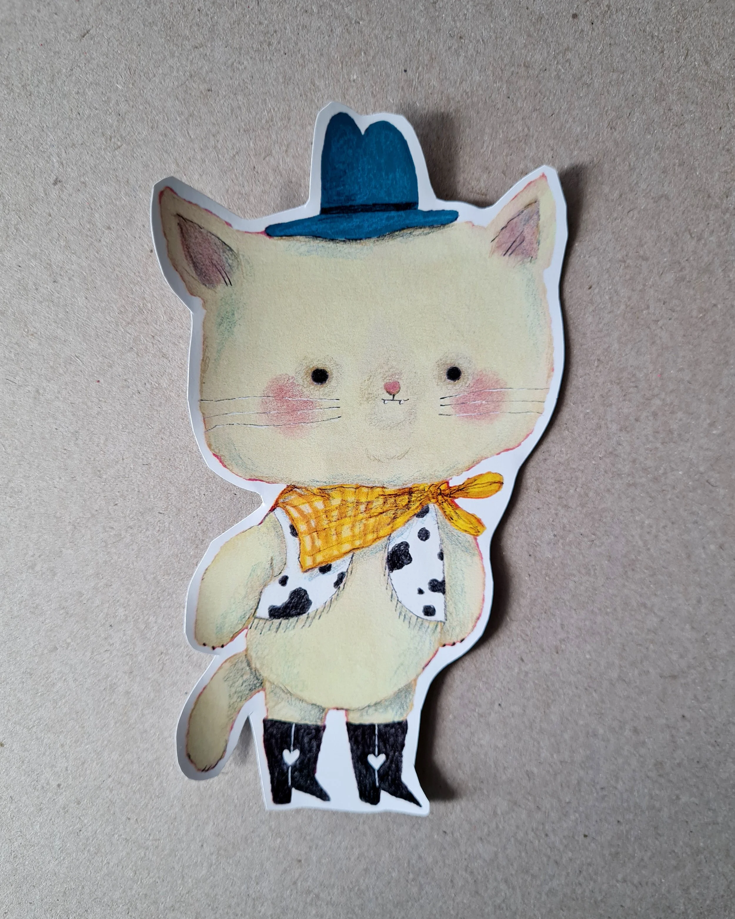 a kitten dressed up as a cowboy