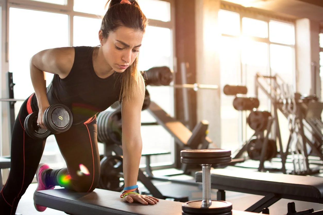 Woman doing a narrow row strength training movement as part of a protein-supported fitness routine for GLP-1 weight loss
