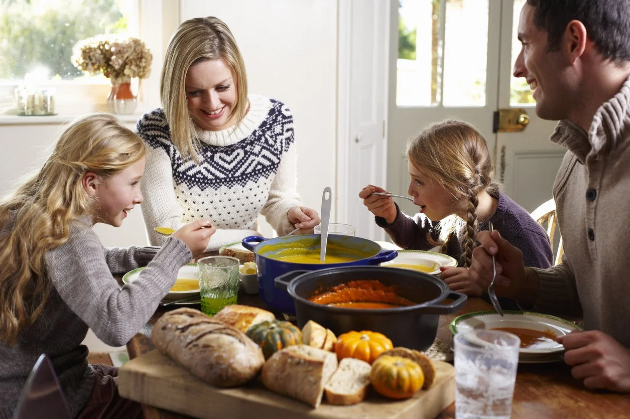 Family enjoying a warm bowl of winter soup as an easy, nourishing dinner option.