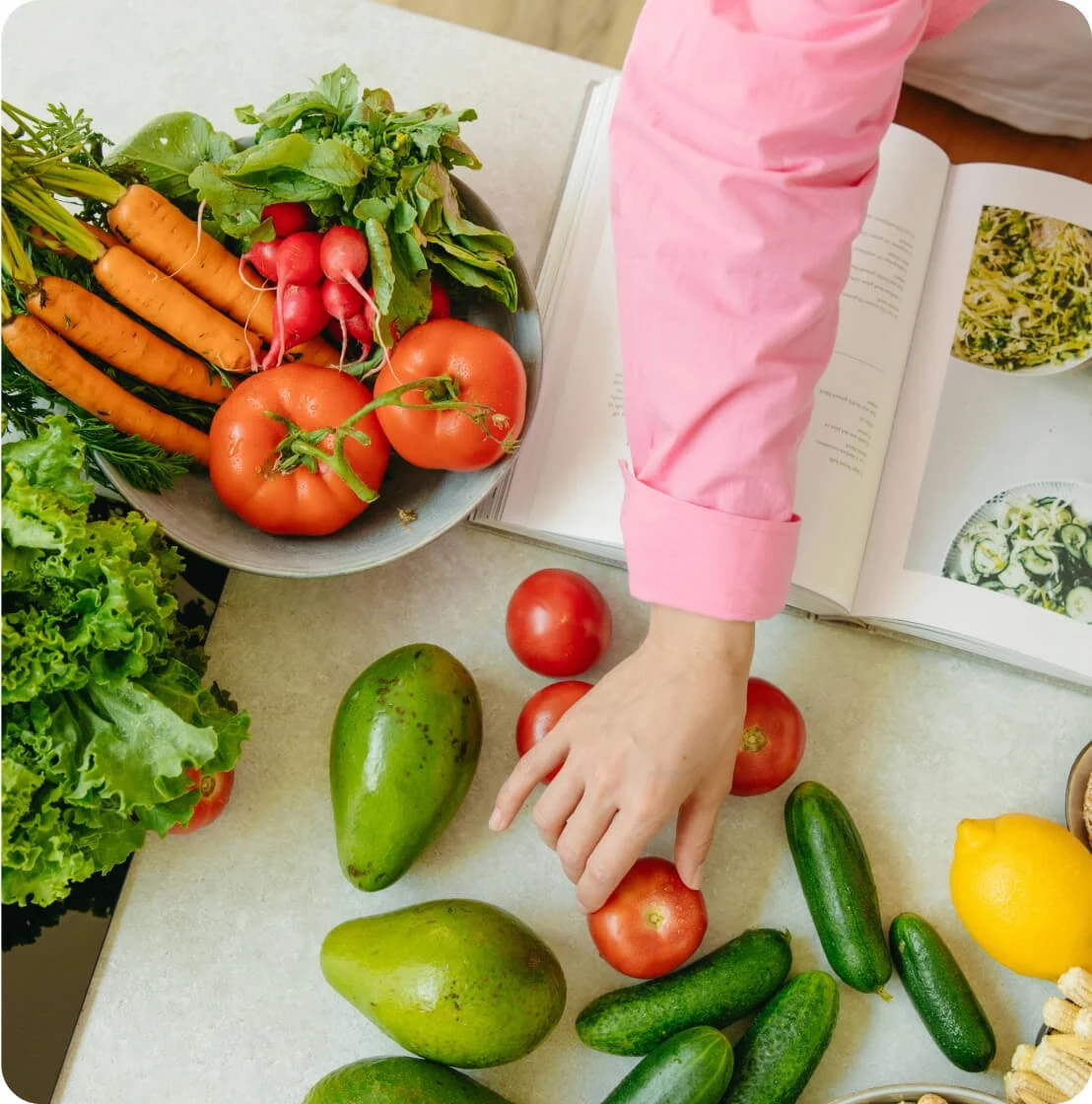 Fresh vegetables and cookbook for healthy eating in a mom weight loss program