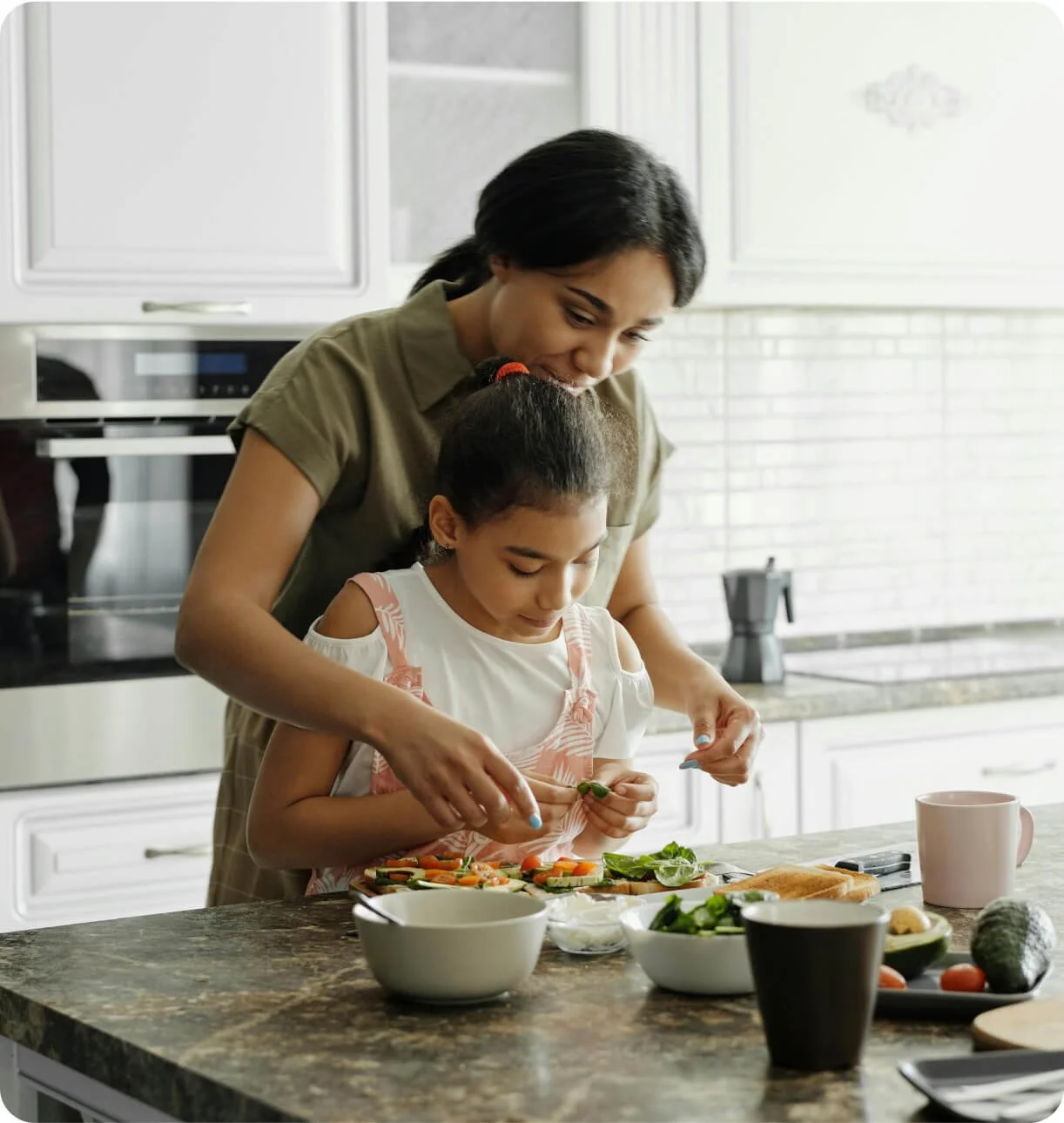 Mom and daughter cooking a healthy meal together as part of a sustainable weight loss lifestyle
