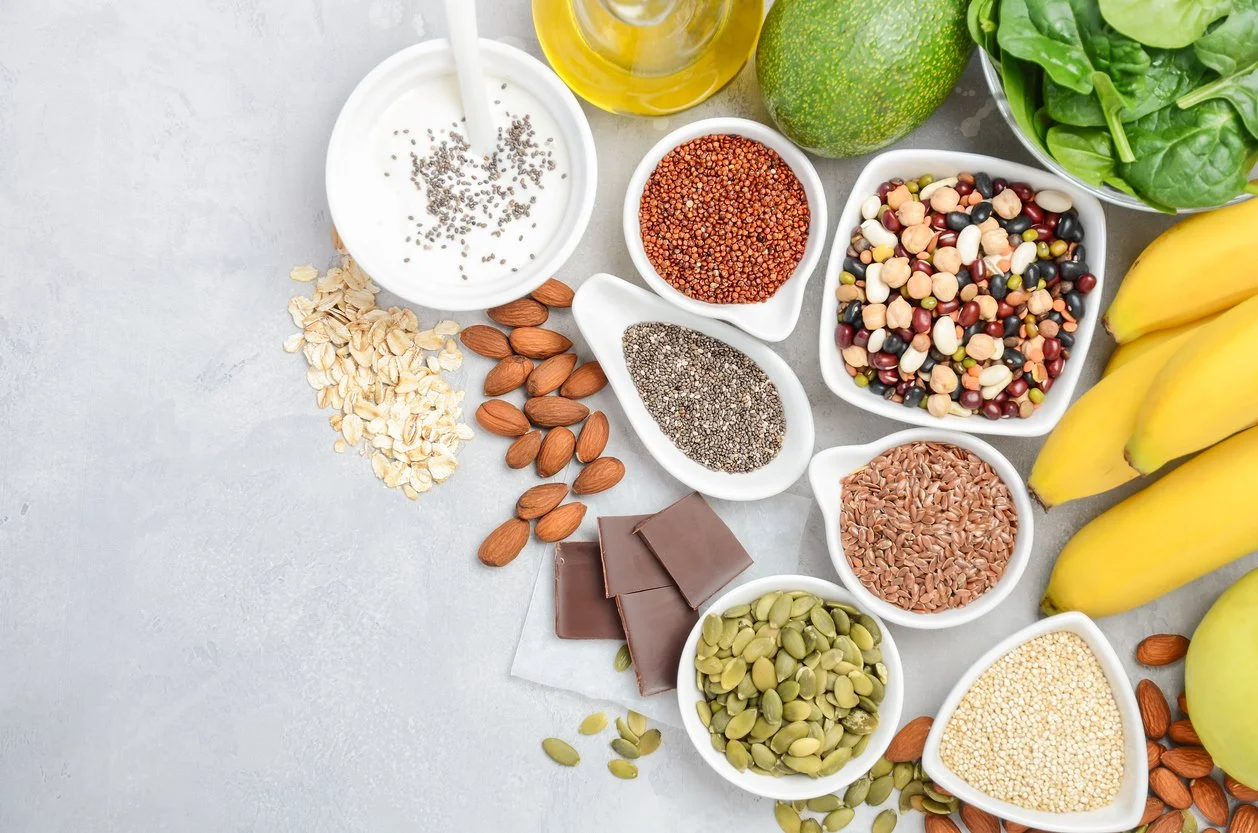 Magnesium-rich foods including spinach, pumpkin seeds, almonds, beans, and quinoa to support women during perimenopause.
