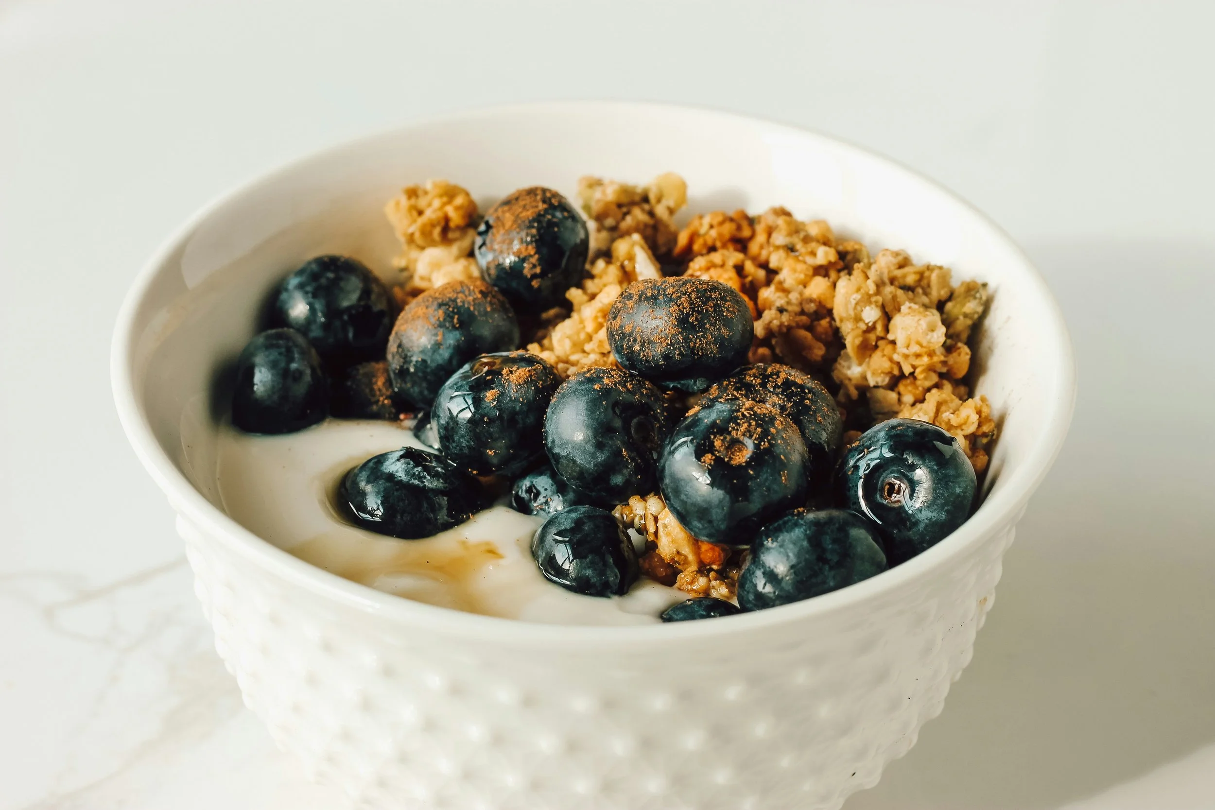 Balanced after school snack with Greek yogurt, berries, and granola showing protein and fiber
