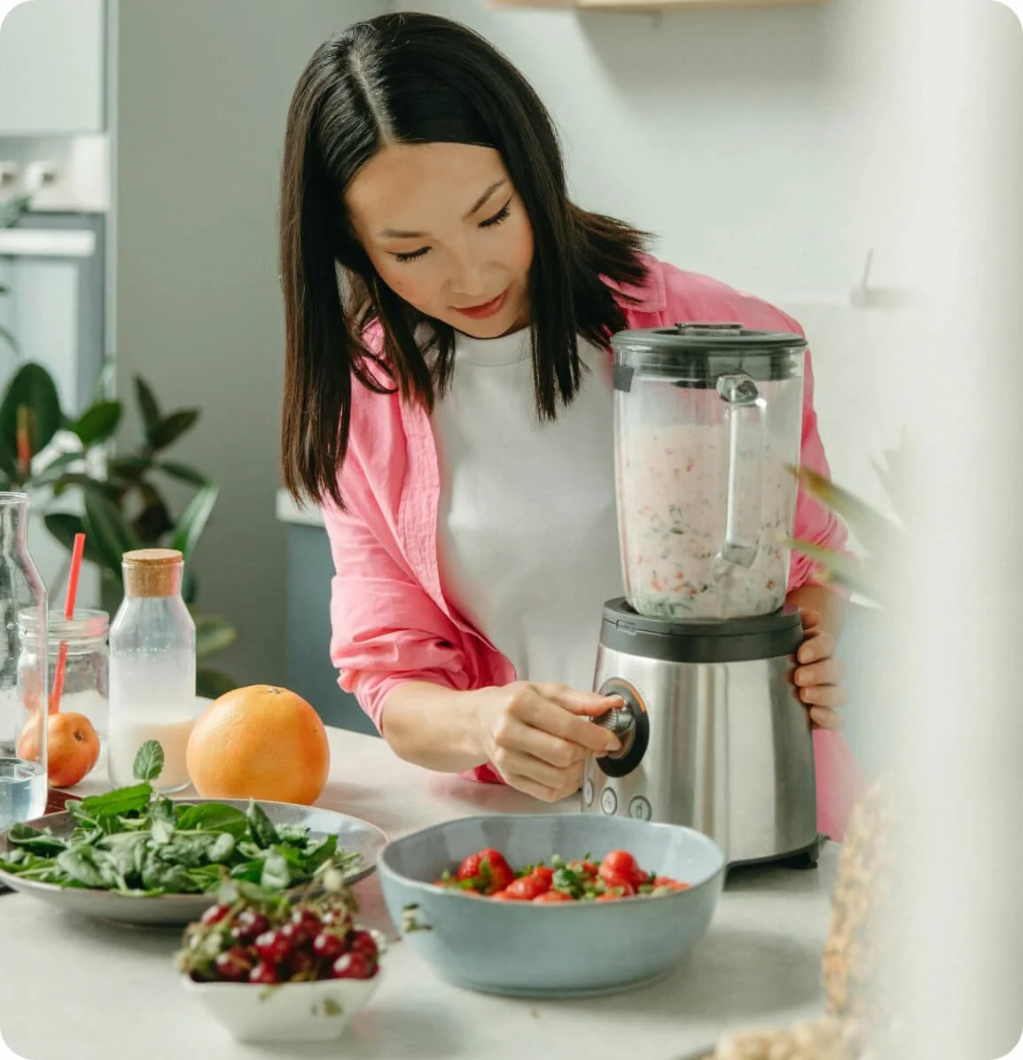 Mom preparing a healthy smoothie as part of a balanced weight loss nutrition plan