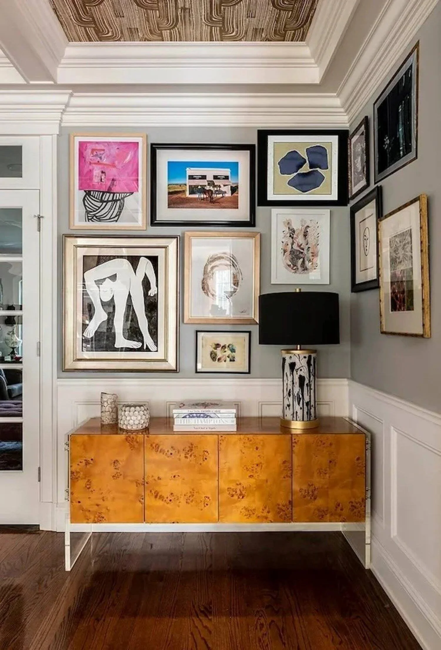 New Canaan residence entry with a curated gallery wall, burled wood console and patterned ceiling inset.
