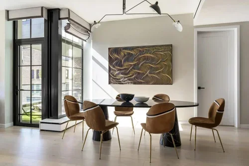 Luxury living room from the studio portfolio with a bold blue geometric rug, blush chairs and a black marble fireplace.