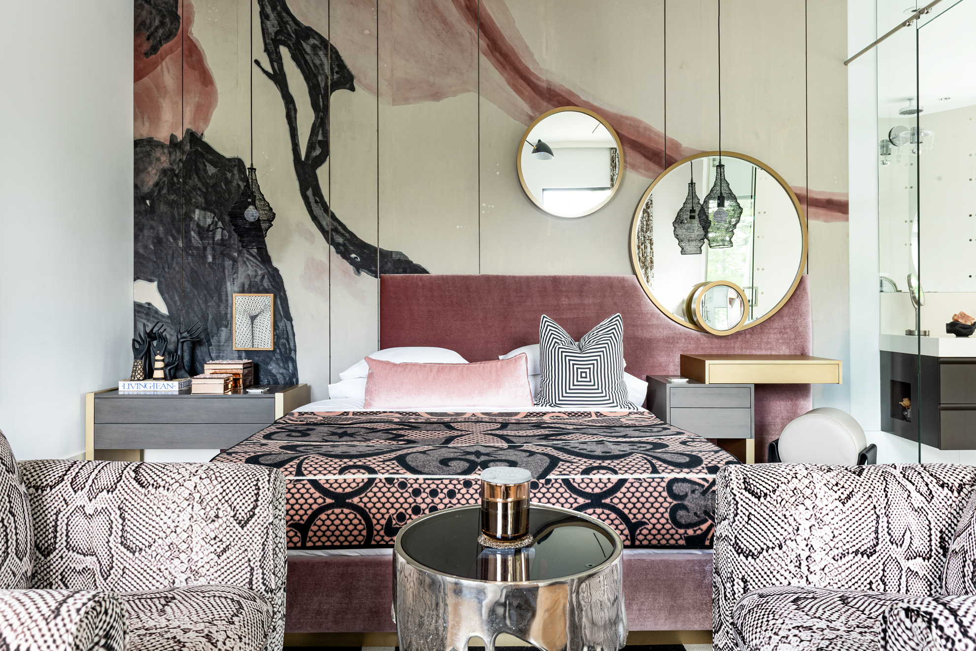 Modern luxury home in Houston guest bedroom seating area with snakeskin chairs, window seat and patterned curtains.