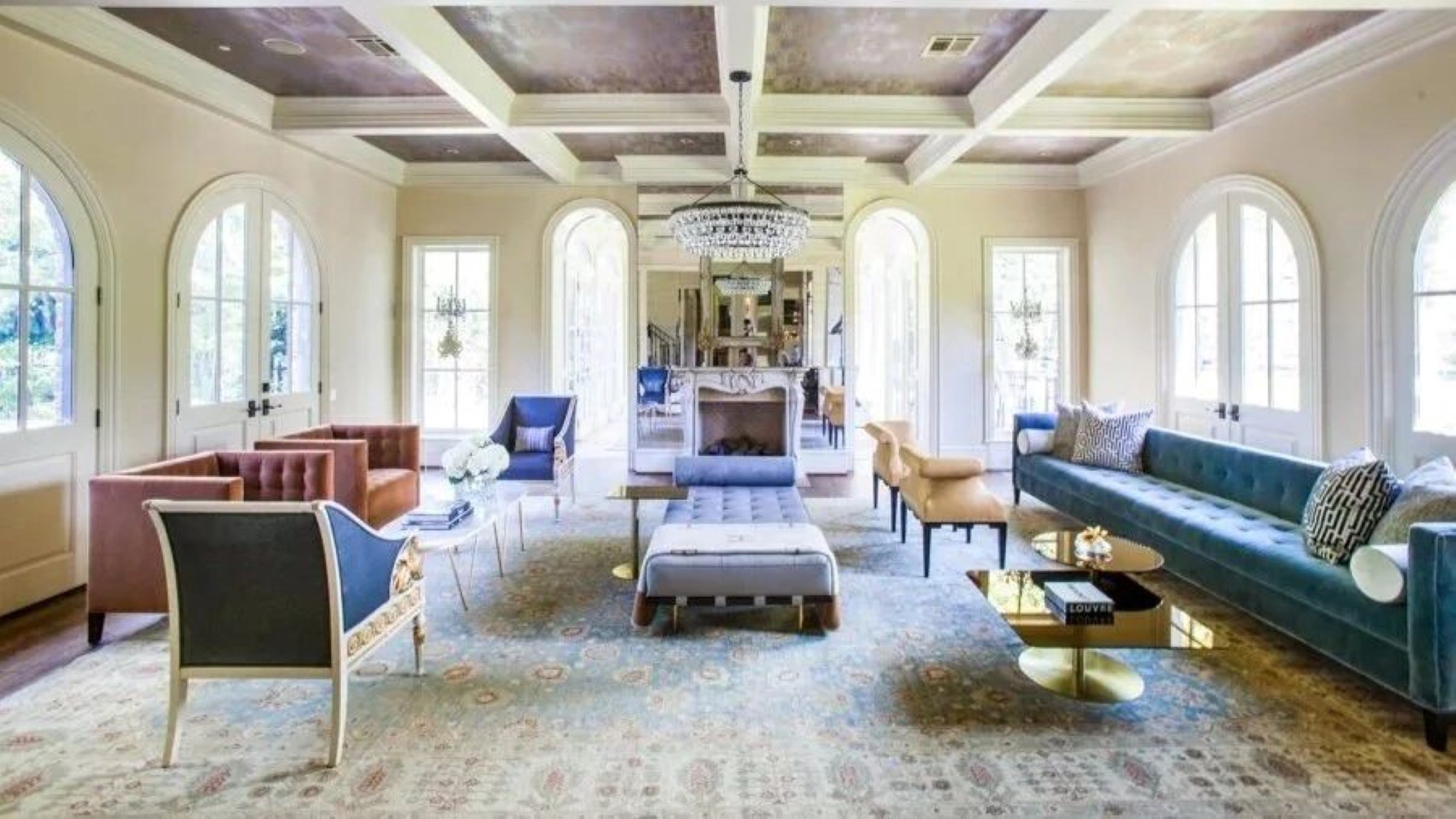 Bluebonnet residence living room in Houston with arched windows, blue velvet seating and a decorative coffered ceiling.