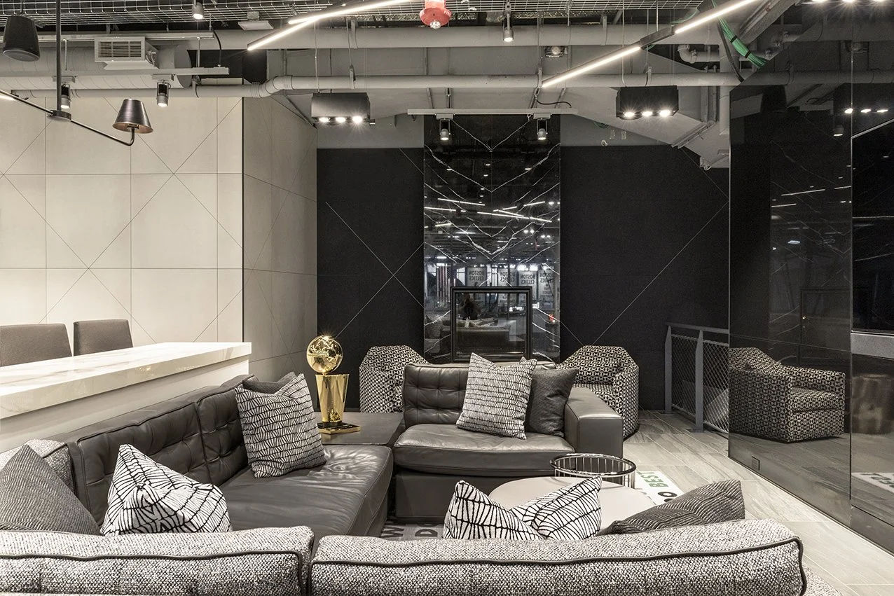 Houston commercial interior design in Montrose with monochrome lounge seating, graphic upholstery and integrated lighting.