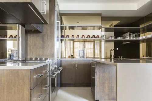 Interior designer New York Upper West Side kitchen with warm wood cabinetry, stainless steel appliances and clean lines.