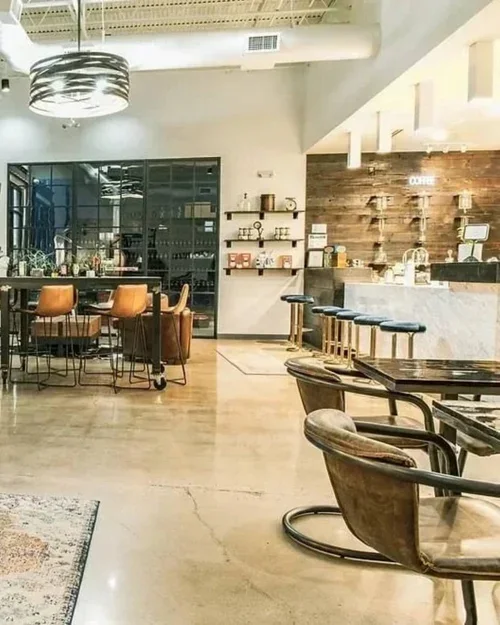 Commercial interior design project at Cavo Coffee, featuring an industrial-style cafe with leather seating and marble bar.