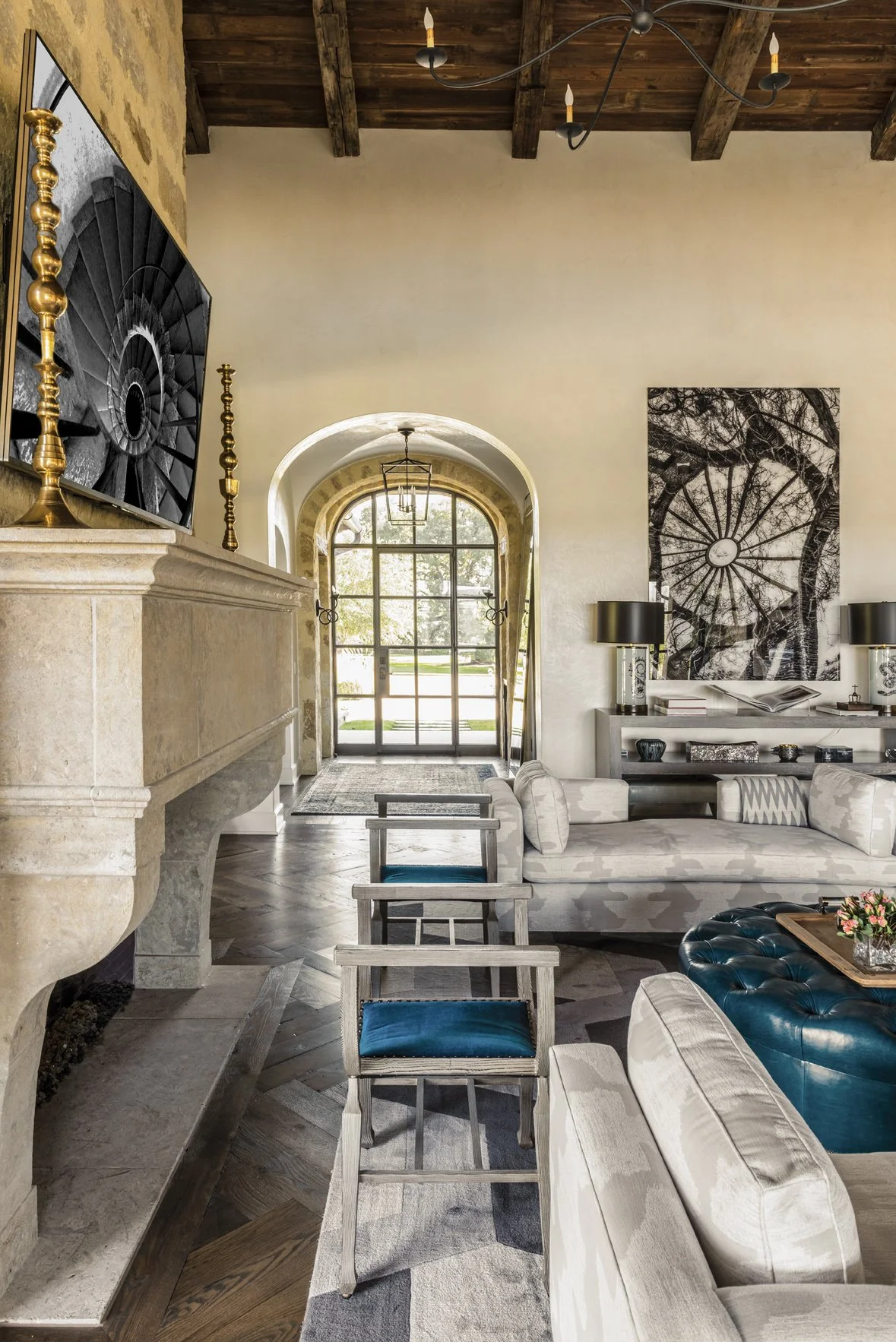 Modern ranch interior design in the Houston Oaks great room, opening to a bright kitchen beneath reclaimed wood beams.