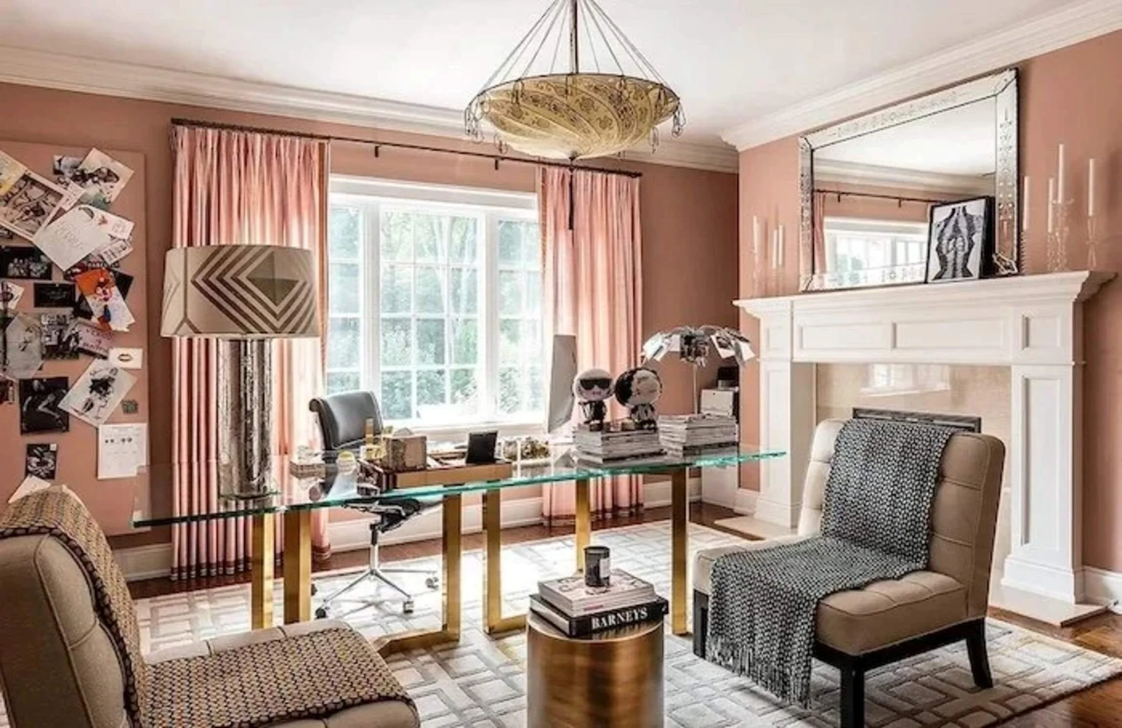 New Canaan residence home office with pink walls, a glass desk, fireplace and layered design references.