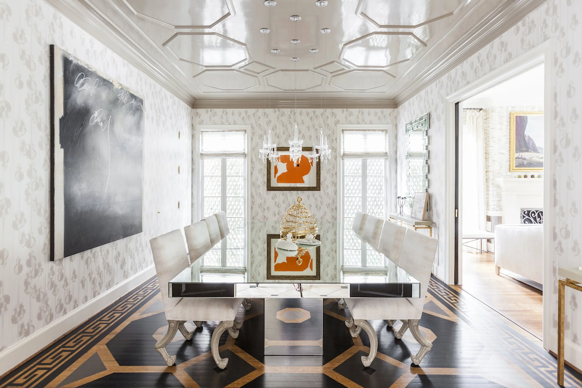 Upper East Side dining room with geometric wood flooring, mirrored table, crystal chandelier and contemporary artwork.