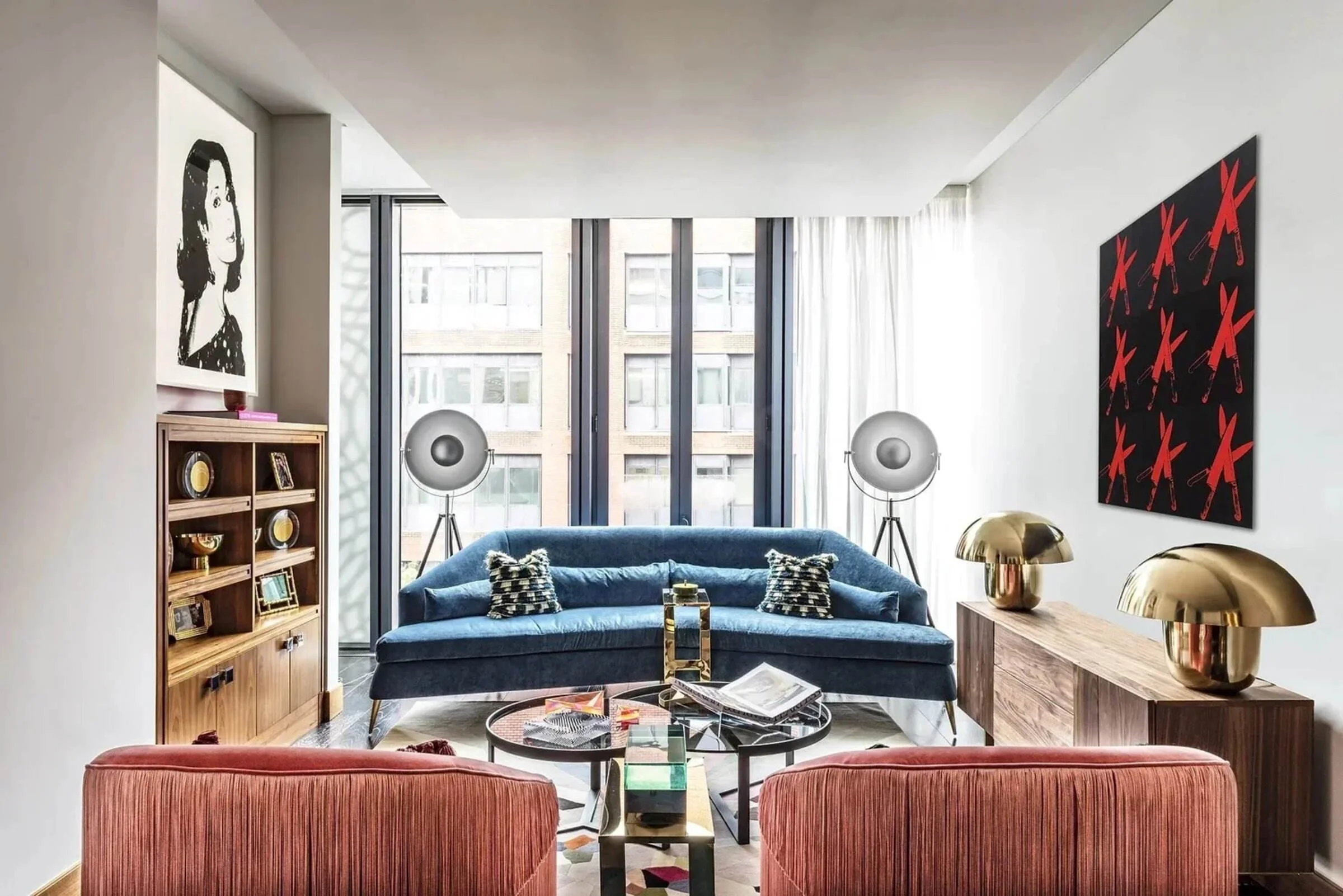 Mayfair London apartment living room with blue velvet seating, brass lighting and contemporary art.