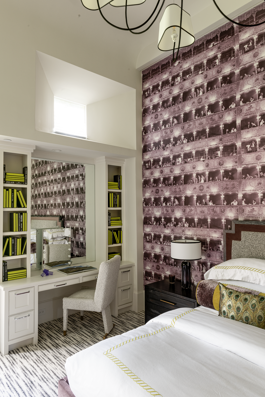 French country home in Houston guest bedroom with built-in desk, mirrored vanity, purple wall covering and tailored bedding.