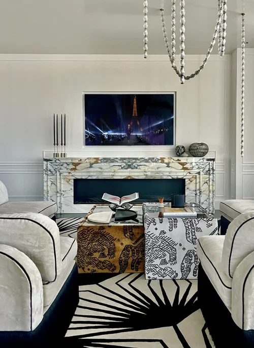 Residential interior design in New York with marble fireplace, graphic rug, custom seating and statement lighting.