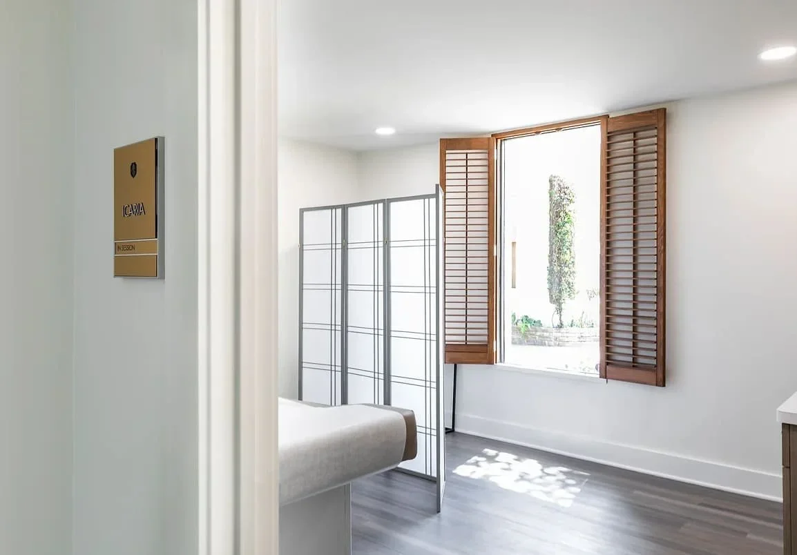 Private clinic treatment room in Houston with clean modern finishes, soft natural light and a calm client-focused interior design approach