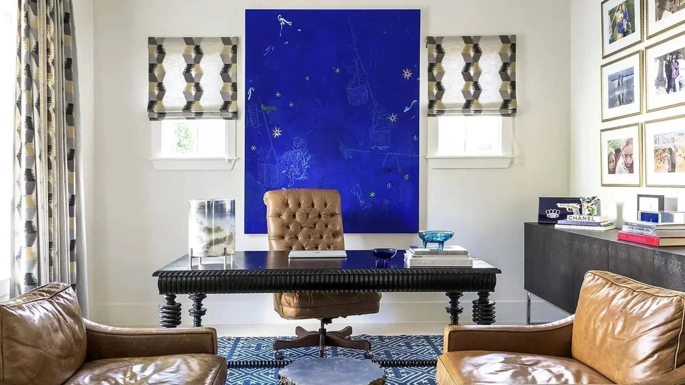 Westheimer residence home office with leather seating, a sculptural black desk and vivid blue contemporary artwork.