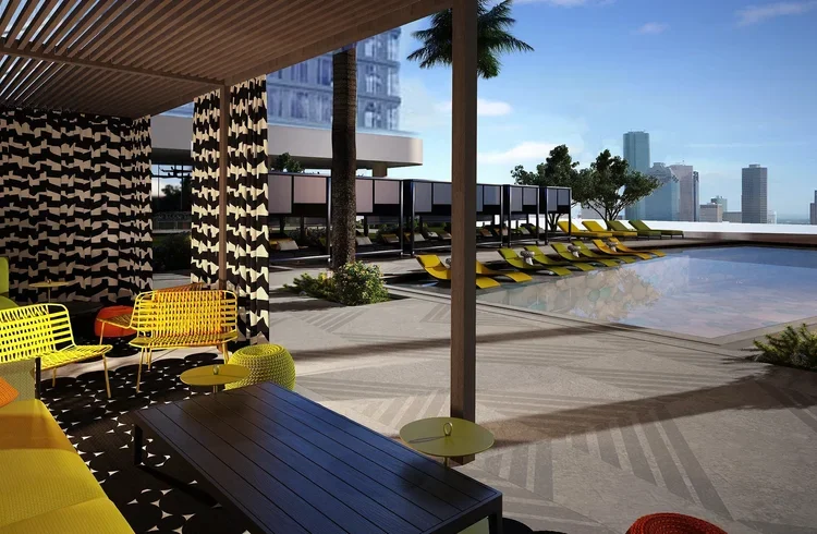 Thompson Hotel Houston rooftop pool deck with a shaded cabana, bold yellow seating and views across the Houston skyline.