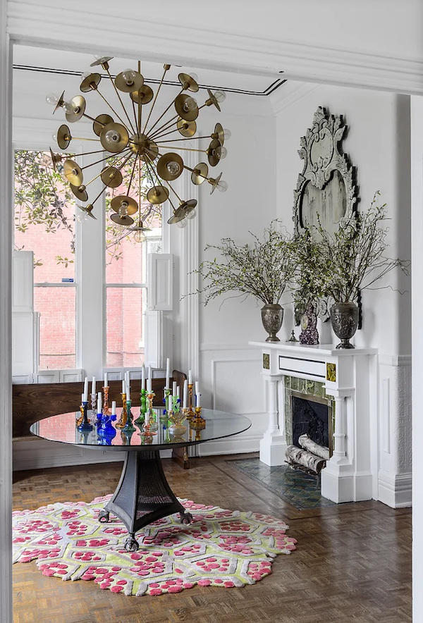 Residential interior design project by a Houston interior designer, featuring a curated dining room with custom lighting, layered textures, and art-forward styling