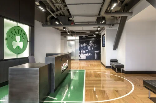 Commercial interior design project for the Boston Celtics, with basketball-court flooring and a contemporary reception desk.