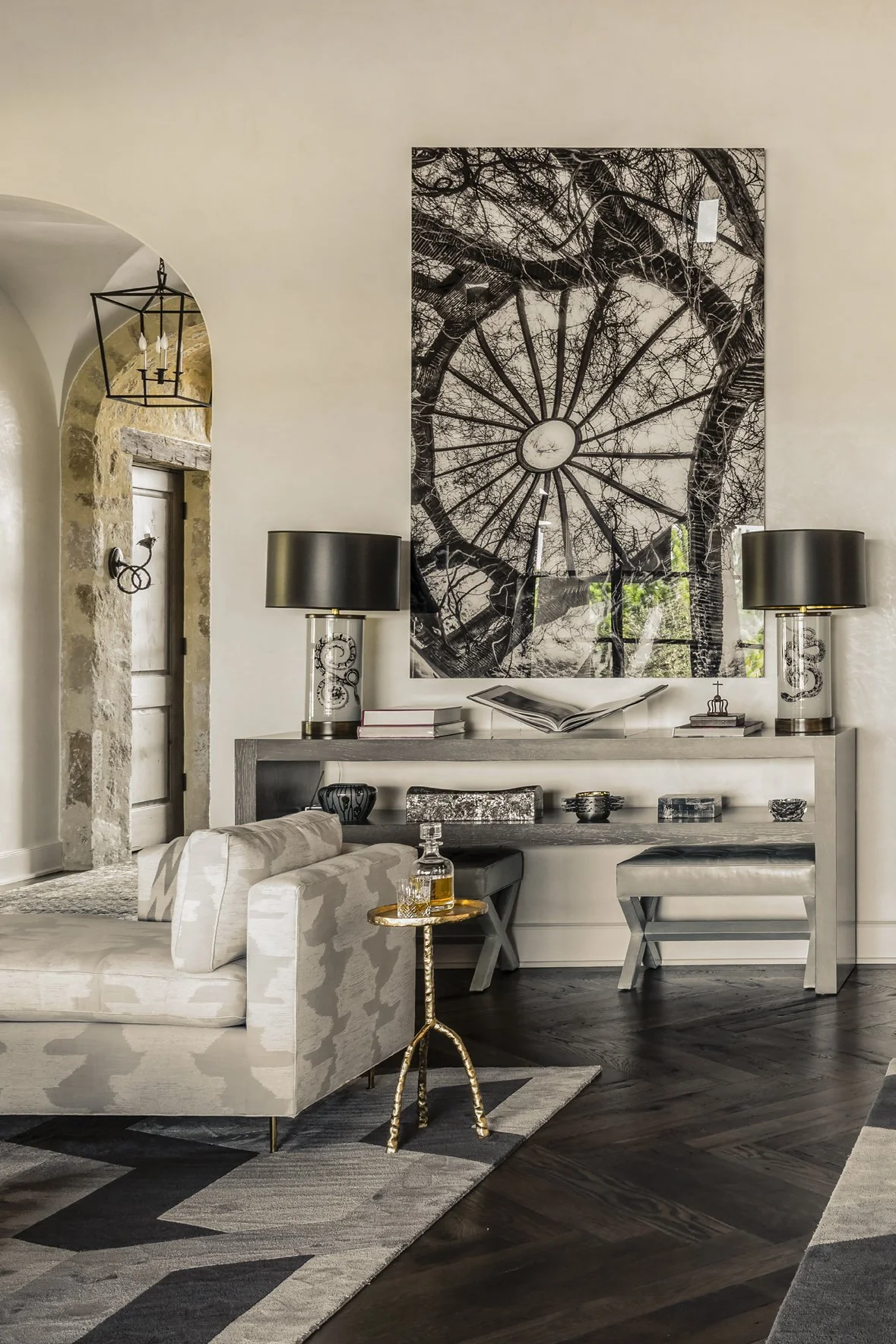 Modern ranch great room detail with contemporary black-and-white art, tailored furnishings and dark wood flooring.