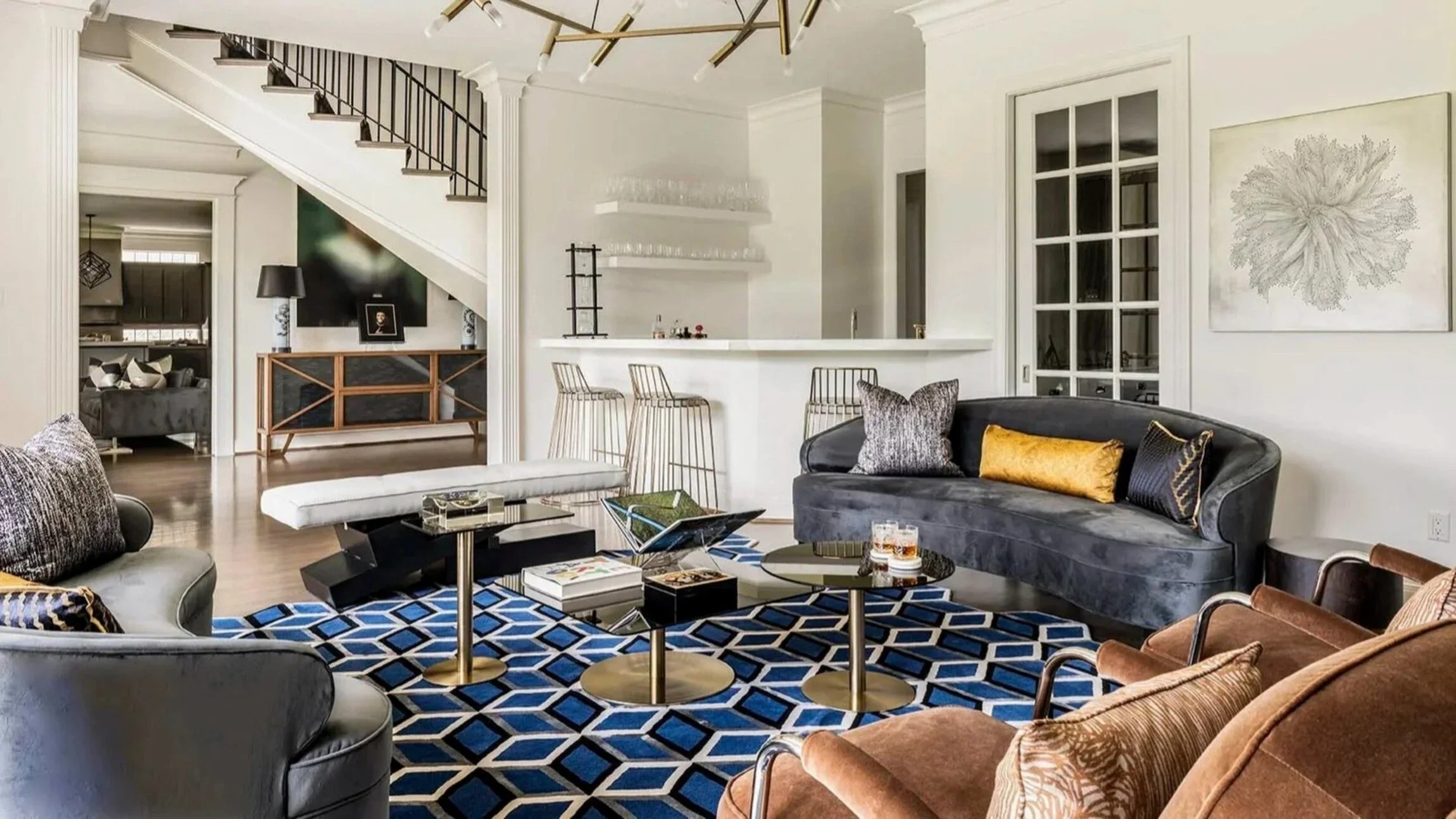 Pastureview residence living room with white sectional seating, patterned armchairs and floor-to-ceiling pool views.