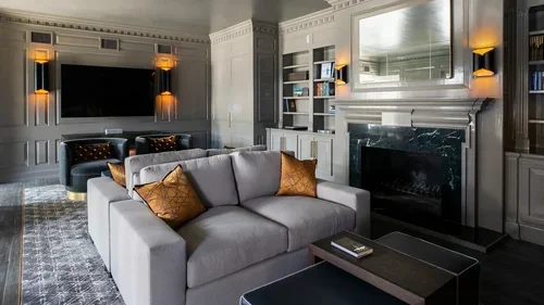 Commercial interior design project at Sydenham Clinic in Houston, with paneled walls, marble fireplace and lounge seating.
