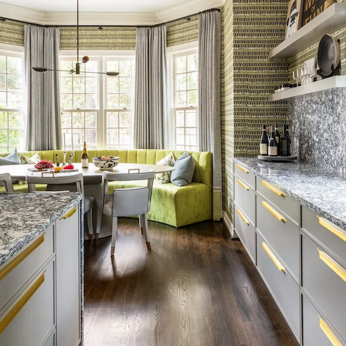 Luxury residential interior design for a kitchen breakfast room with custom banquette seating, layered window treatments, and tailored finishes