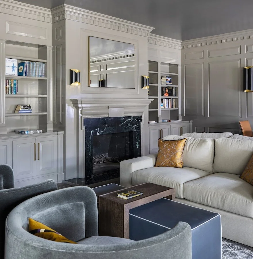 Commercial interior design Houston waiting area at Sydenham Clinic, with tailored seating, built-ins and a marble fireplace.