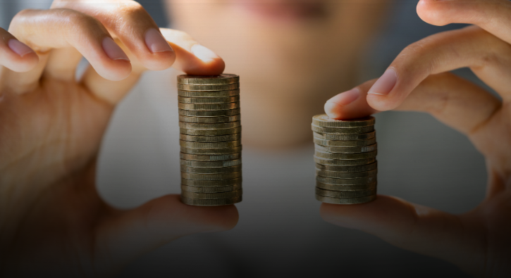 A woman in a beige blazer and white shirt holding a tablet, standing in a data center with purple and blue lighting.