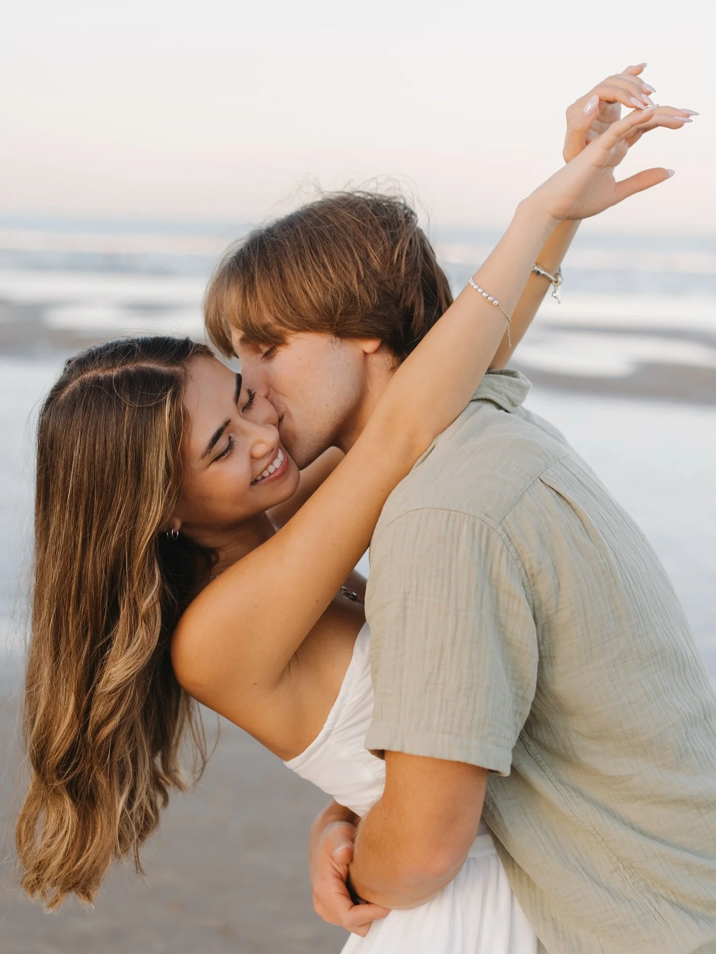 Kylie + Travis&rsquo;s engagement session 💍
_
K + T danced in the sand, splashed in the waves, and soaked up a dreamy summer sunset with pink skies. The @lacopasouthpadre boardwalk added perfect golden-hour glow for their final shots. Congrats to th