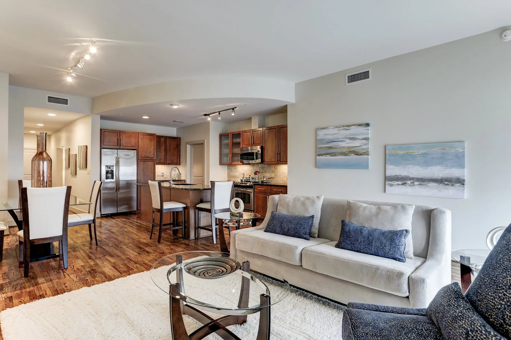 Fully furnished corporate apartment living room with kitchen and dining area