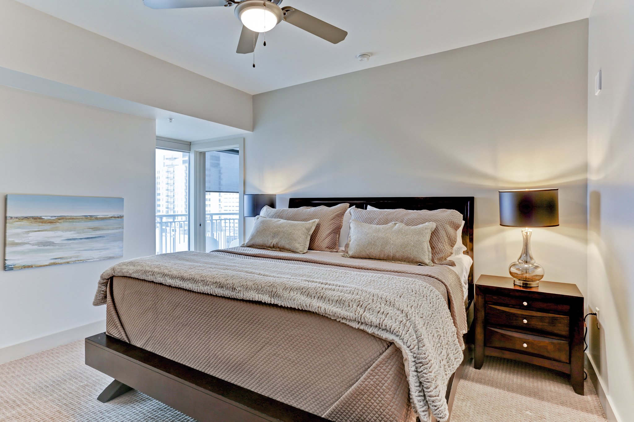Furnished corporate apartment bedroom with comfortable bedding and modern decor